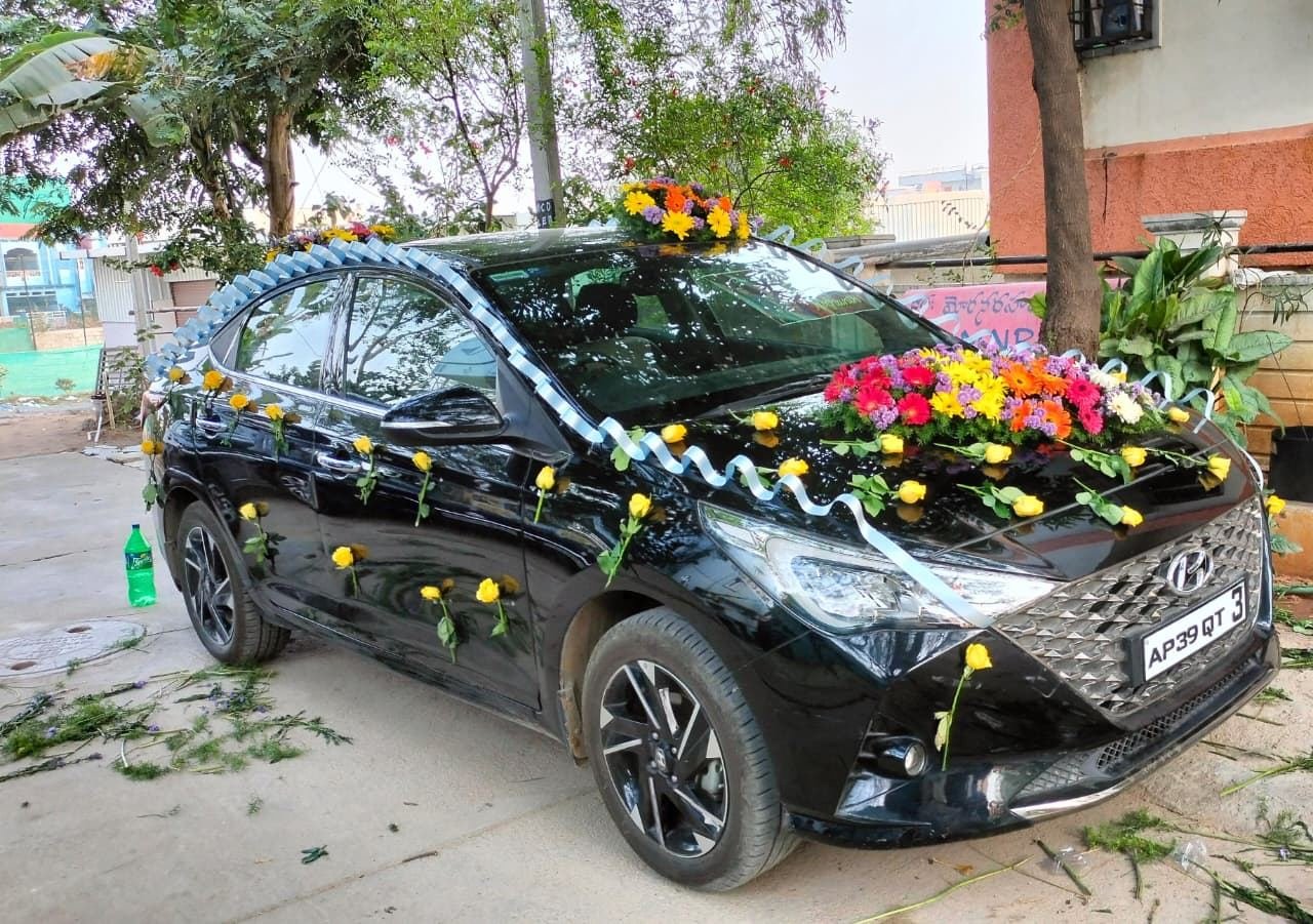 Wedding car decorated with fresh mixed flower garlands