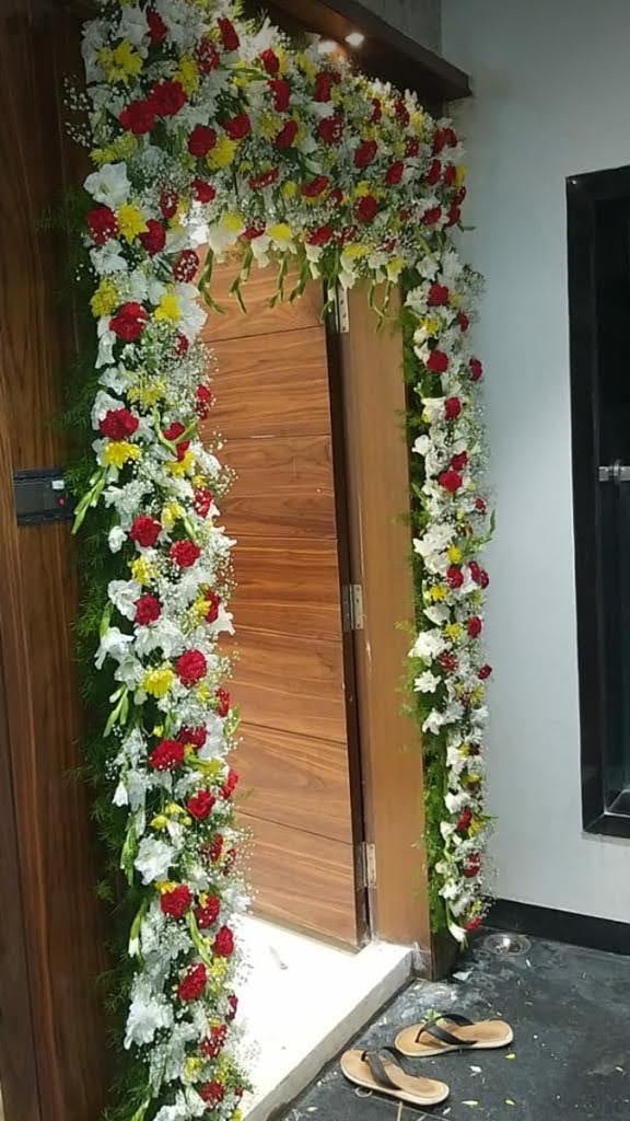 Doorway floral decoration in red white and yellow blooms