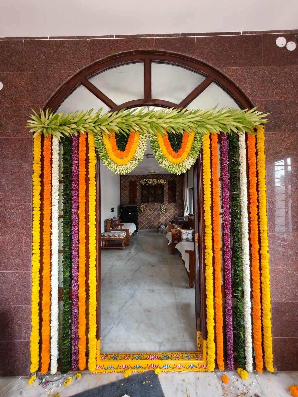 Marigold and banana leaf entrance decoration for housewarming ceremony