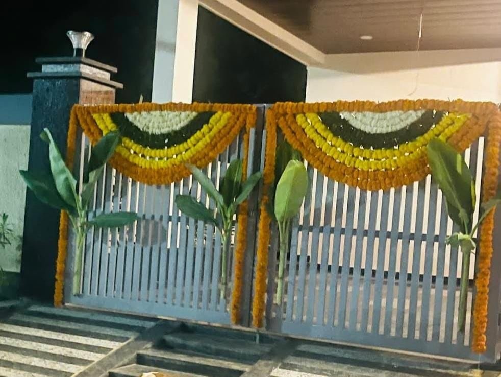Gate marigold swag decoration with banana leaf accents
