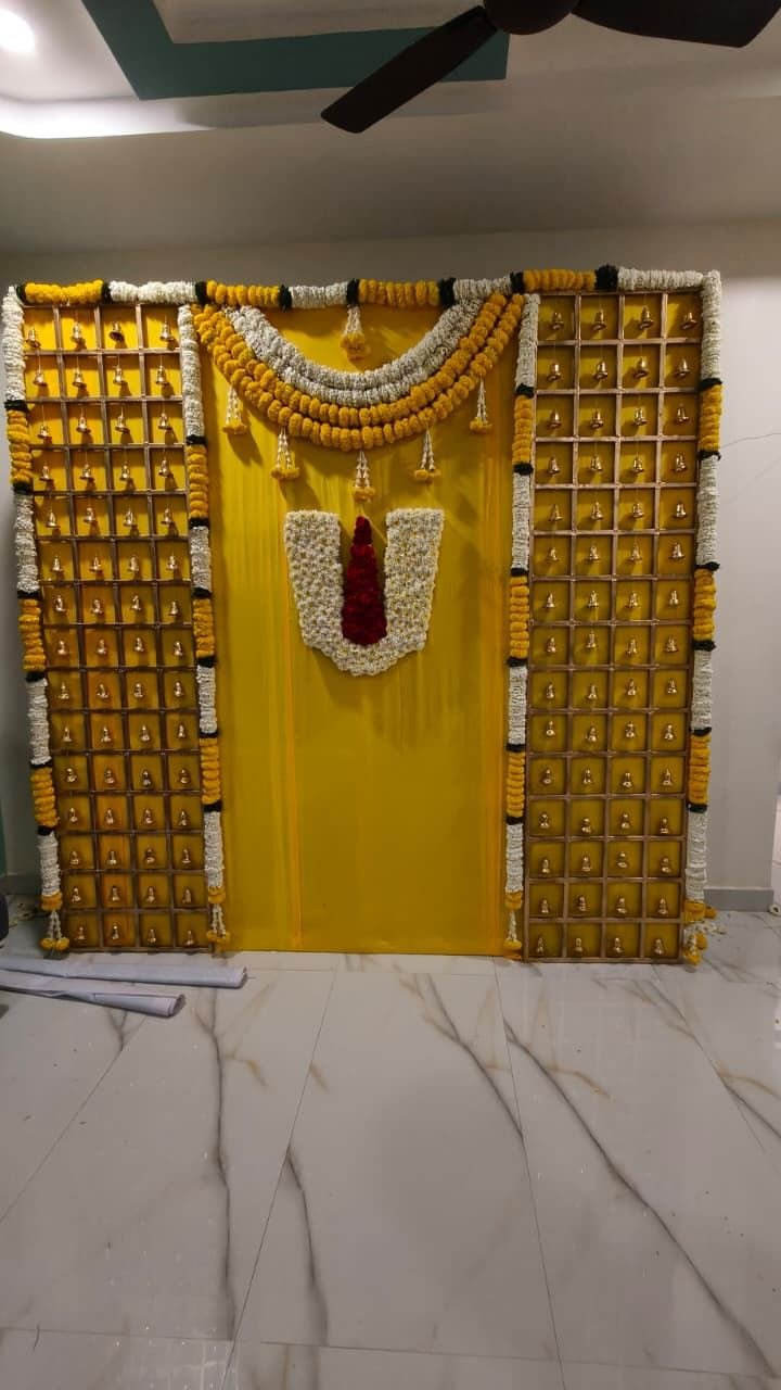 Traditional pooja backdrop with marigold and temple bells