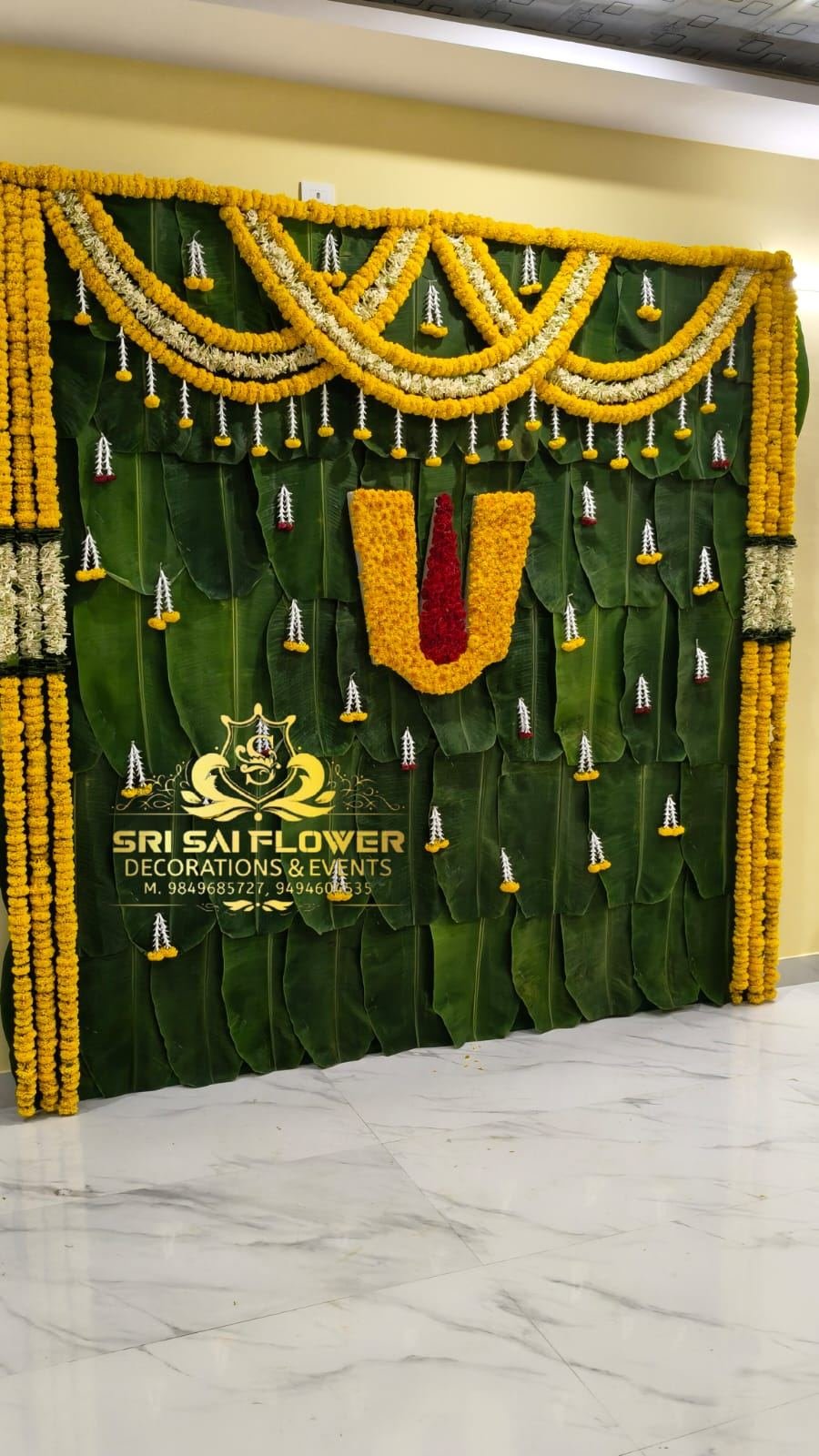 Traditional wedding mandap stage in maroon and gold tones