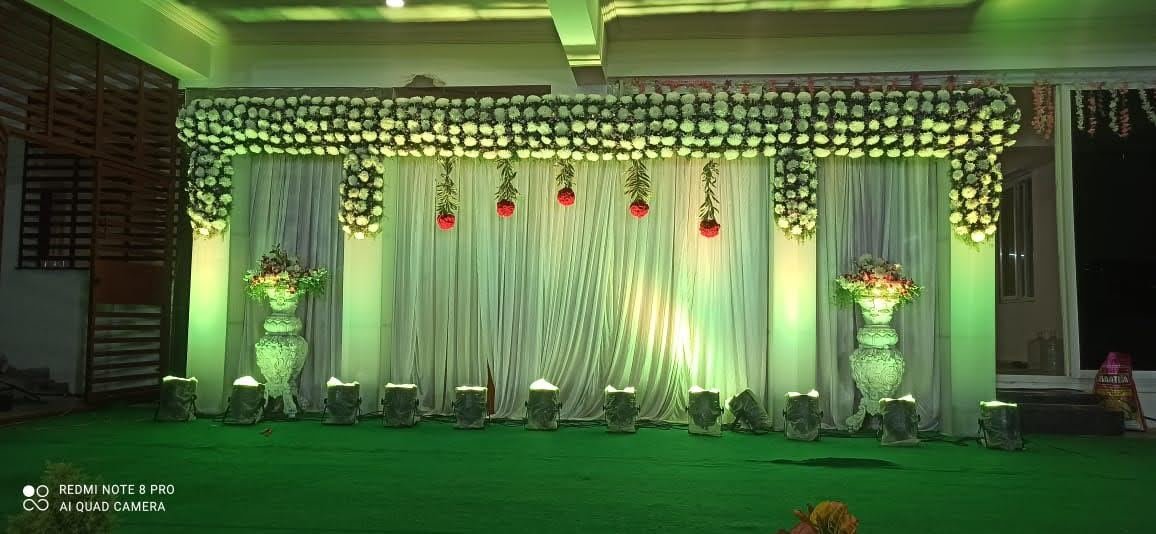 Green and white floral wedding reception stage