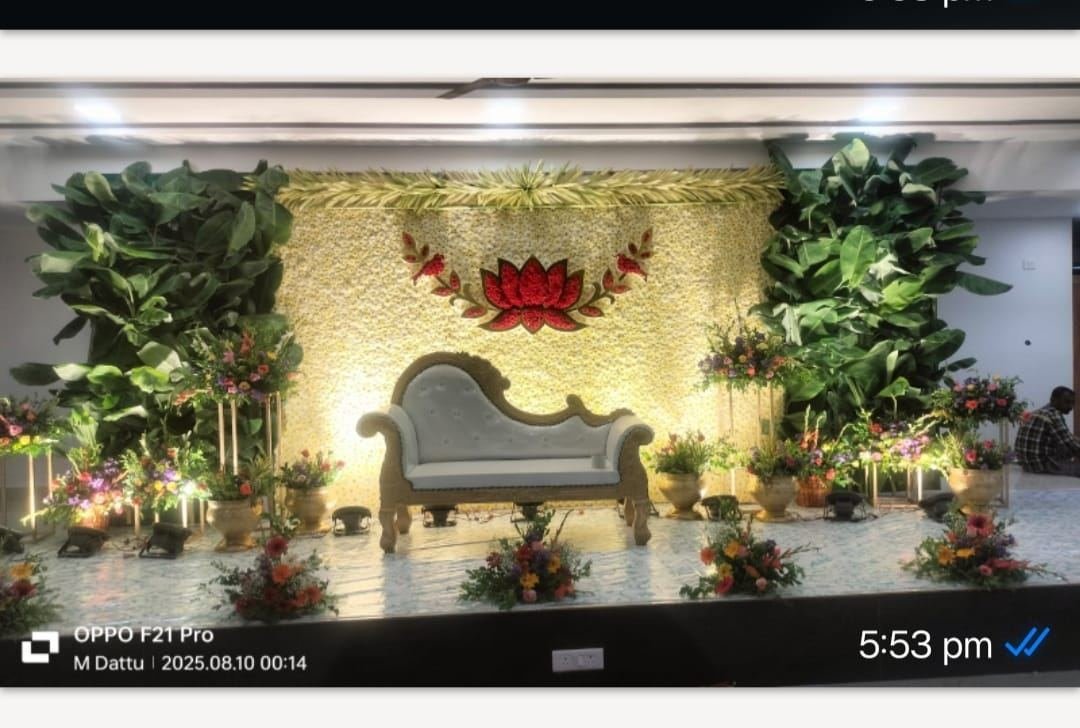 Grand wedding stage with ivory drapes and round floral medallions