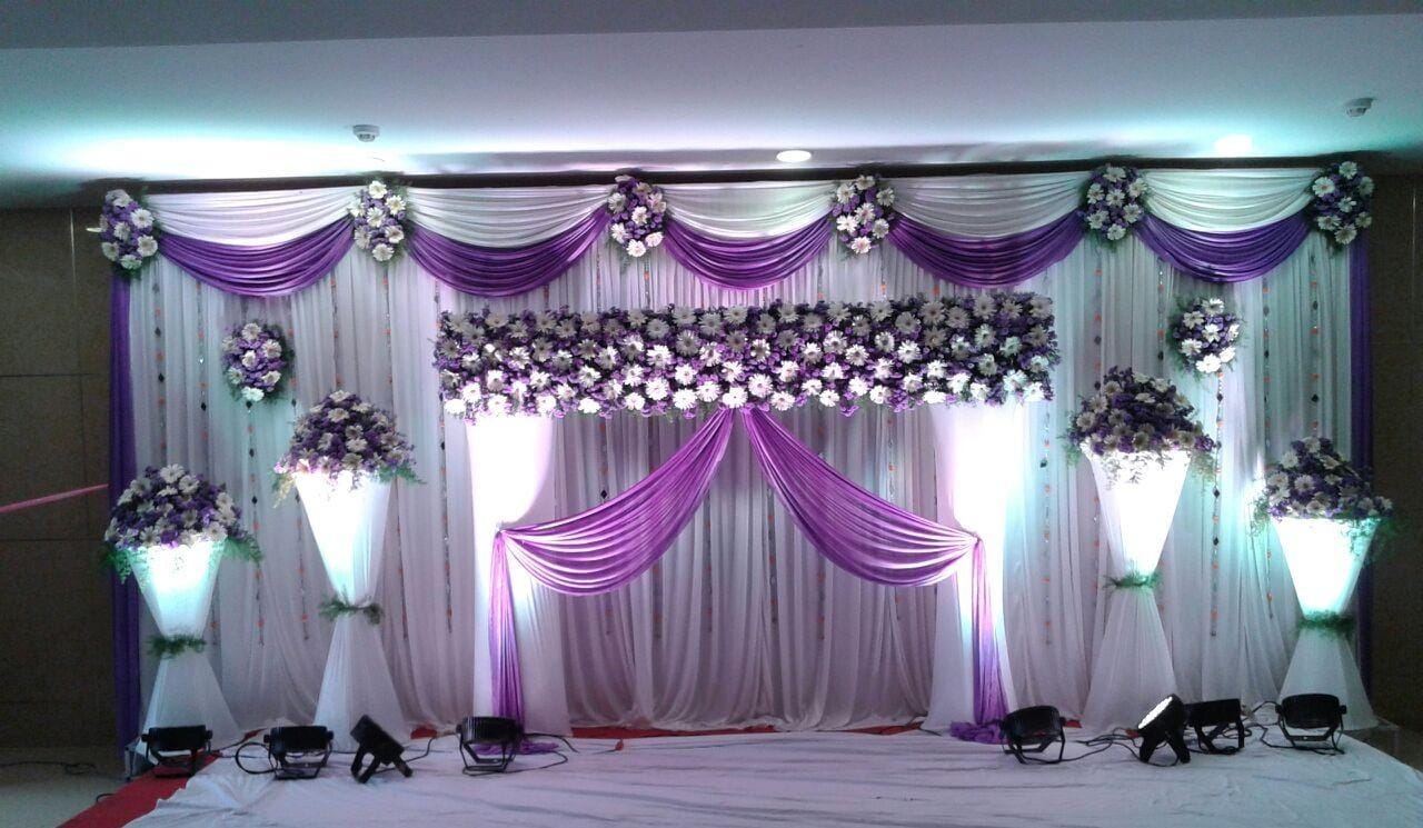 Purple and white floral wedding reception stage